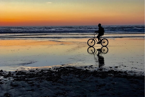 Man riding bike on Beach