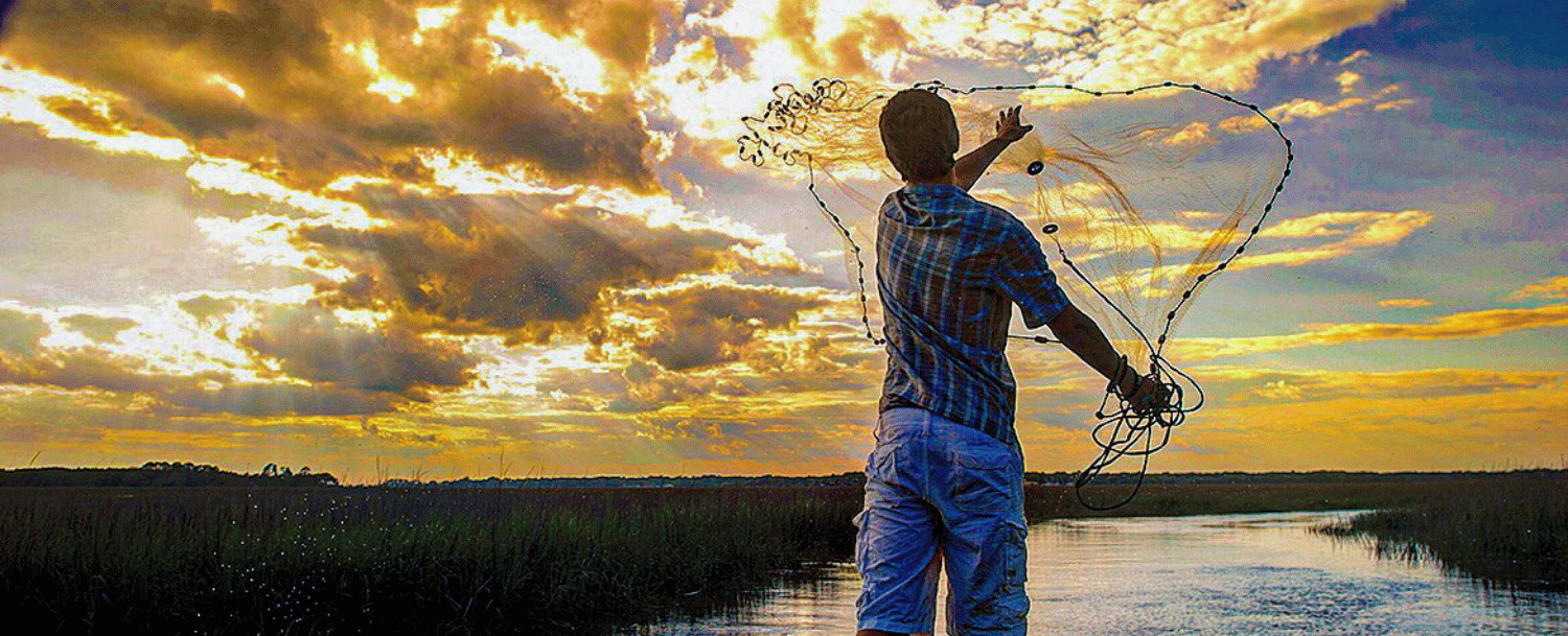 Casting a net with a Johns Island sunset in the background