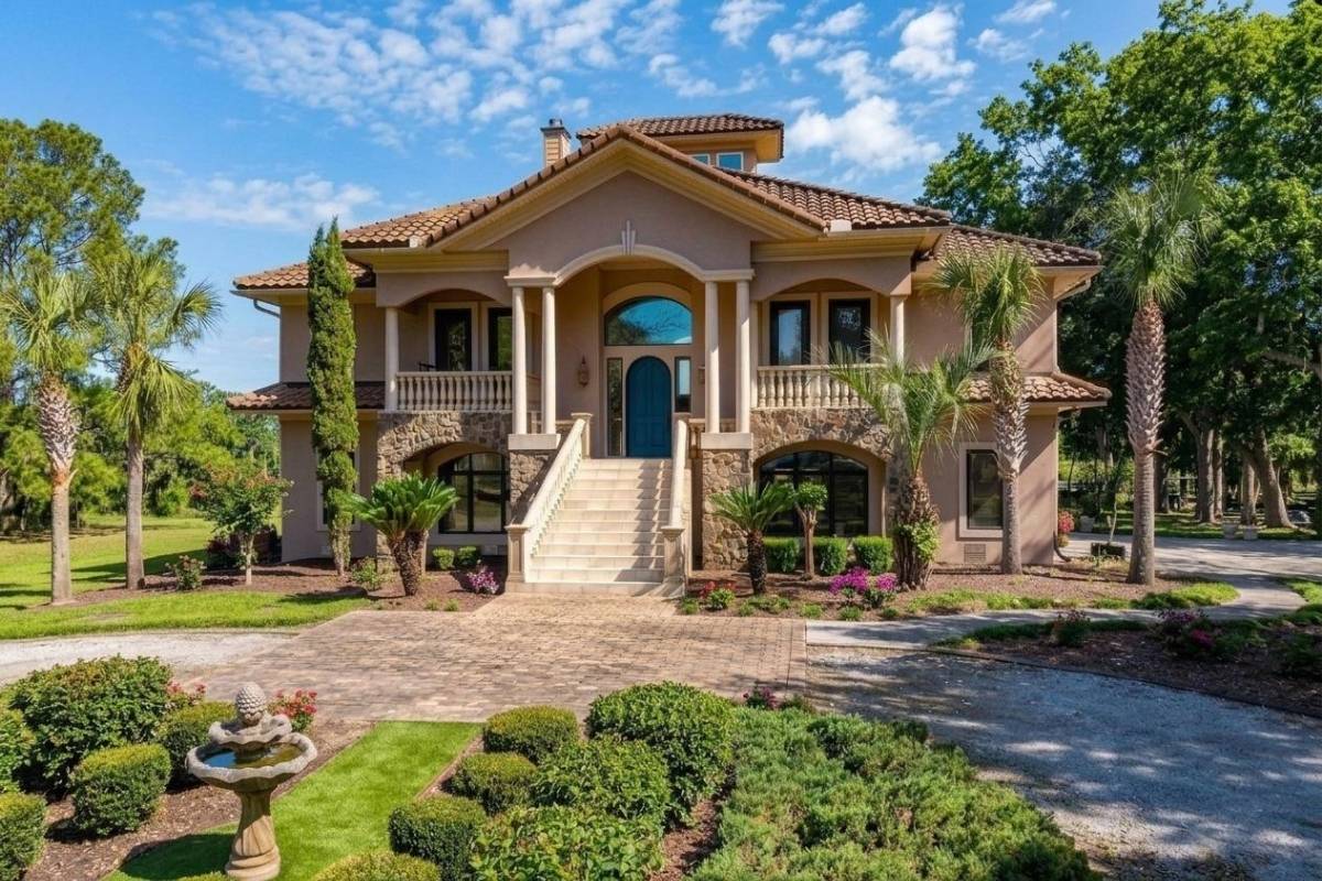 Front exterior of 6411 China Back Lane, Meggett SC — Spanish-style estate with barrel tile roof, stone veneer, and fountain in Archfield Plantation