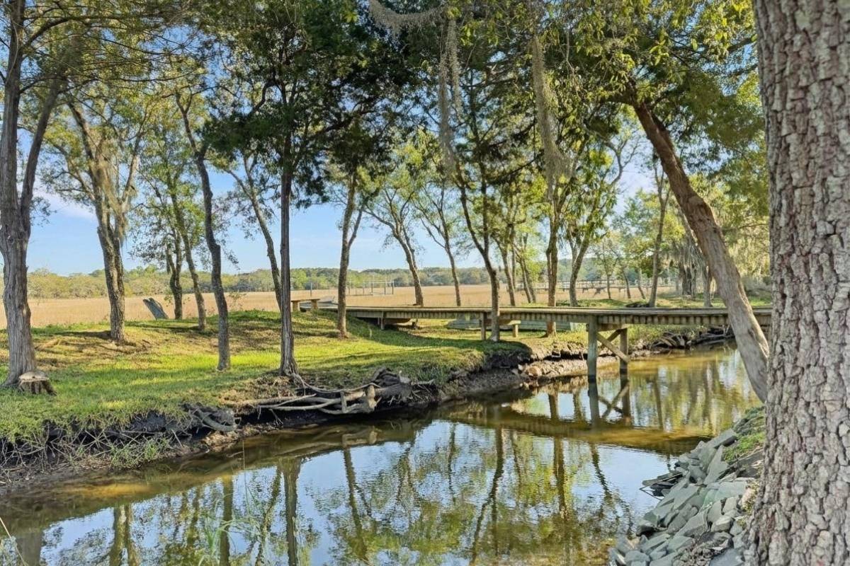 Tidal creek with footbridge and live oaks on the grounds of 6411 China Back Lane, Meggett SC — Archfield Plantation waterfront estate