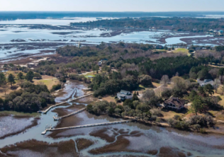 Aerial view of private dock and boardwalk extending through Lowcountry marsh on Oyster House Creek at 6411 China Back Lane, Meggett SC — Archfield Plantation
