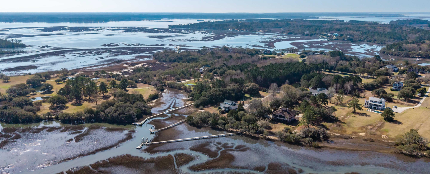Aerial view of private dock and boardwalk extending through Lowcountry marsh on Oyster House Creek at 6411 China Back Lane, Meggett SC — Archfield Plantation