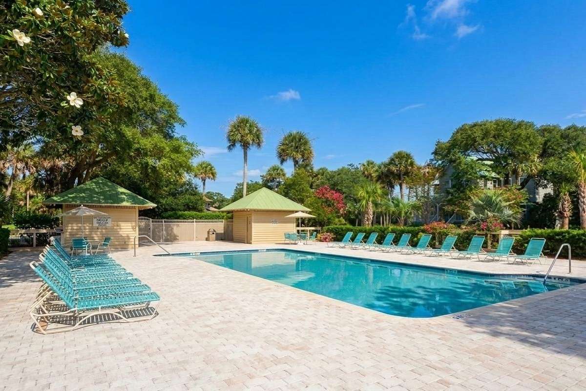 Atlantic Beach community pool with lounge chairs, pool house, and palmetto trees, The Enclave at Turtle Beach, Kiawah Island