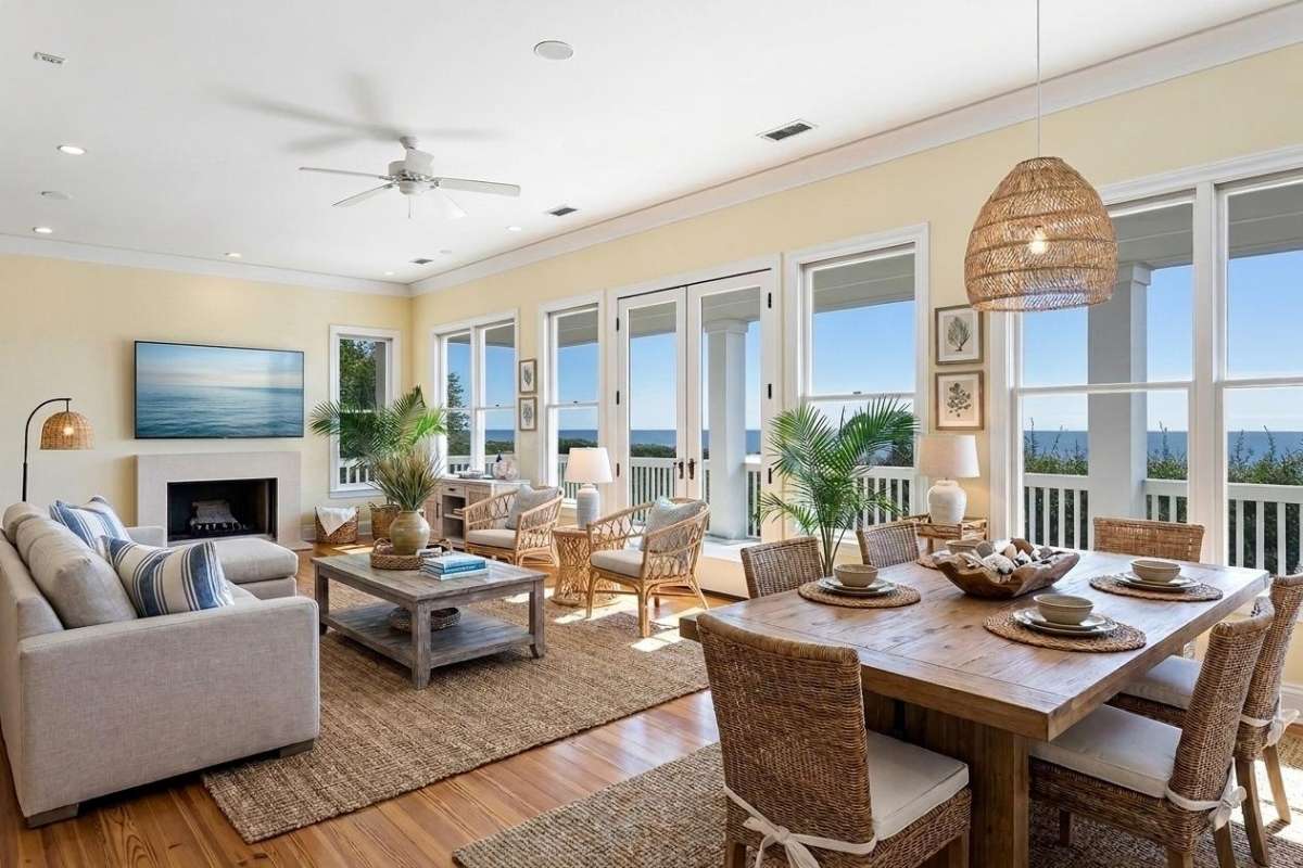 Bright coastal living and dining room with ocean views through French doors at an Atlantic Beach home, Kiawah Island