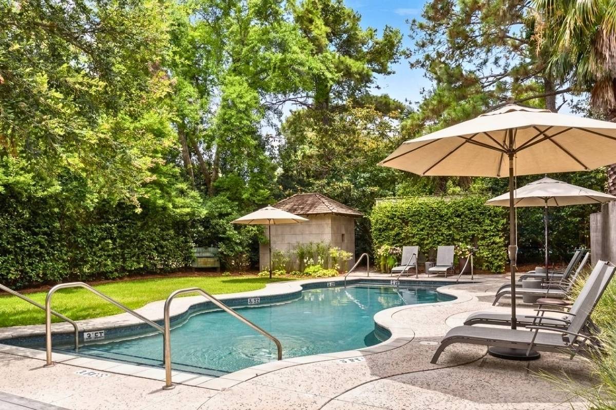 Cypress Point community pool surrounded by tall pines and lush landscaping in East Beach Village, Kiawah Island