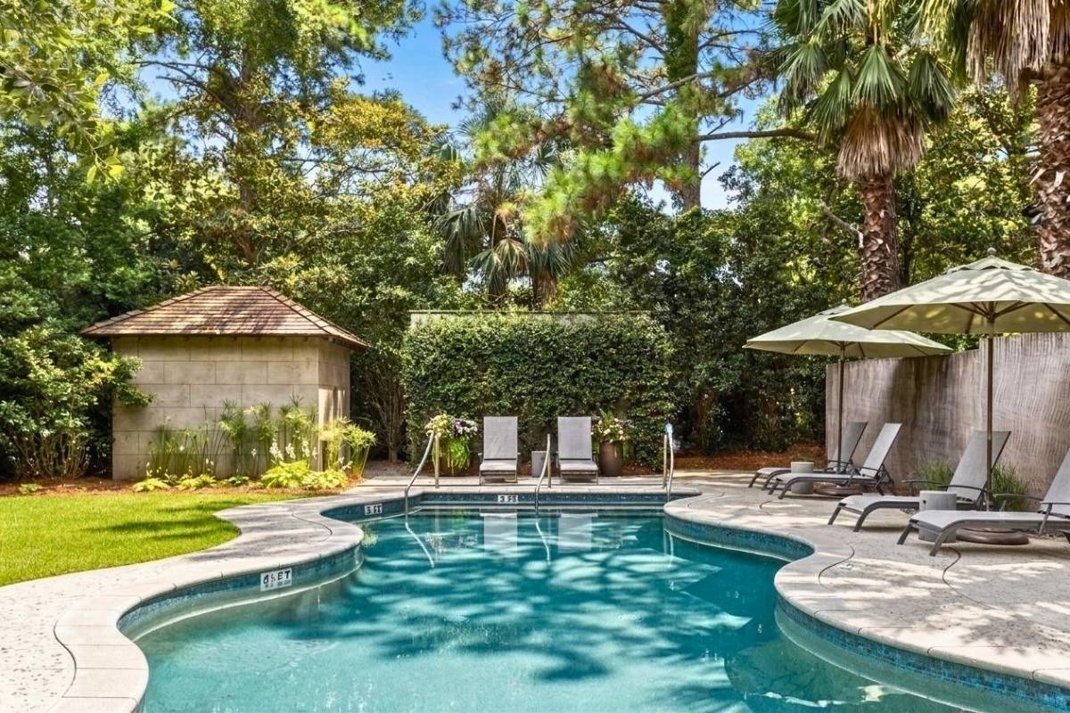 Shaded pool and lounge seating at Cypress Point cottage community, East Beach Village, Kiawah Island