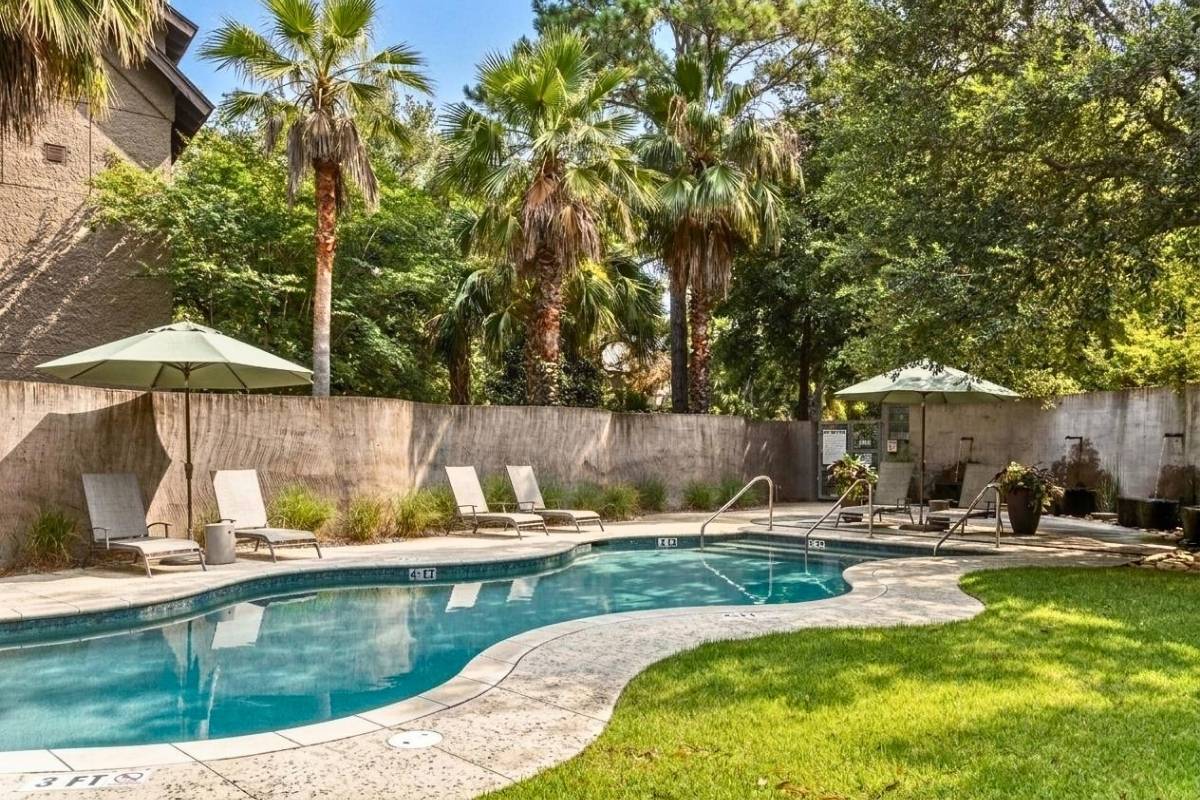 Cypress Point community pool with palm trees and lounge seating, East Beach Village, Kiawah Island