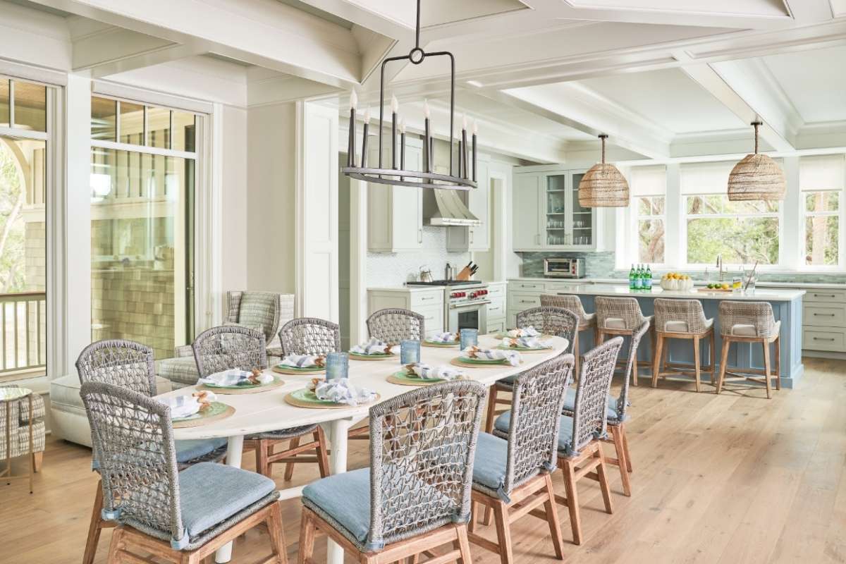 Open-plan dining room and kitchen of a custom Ocean Park home on Kiawah Island with coastal furnishings and coffered ceiling