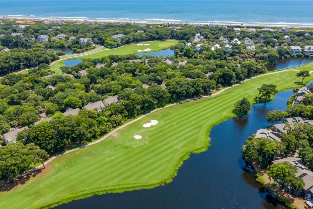 Aerial view of Turtle Point Golf Course, lagoons, and Turtle Beach homes with the Atlantic Ocean in the background, Kiawah Island