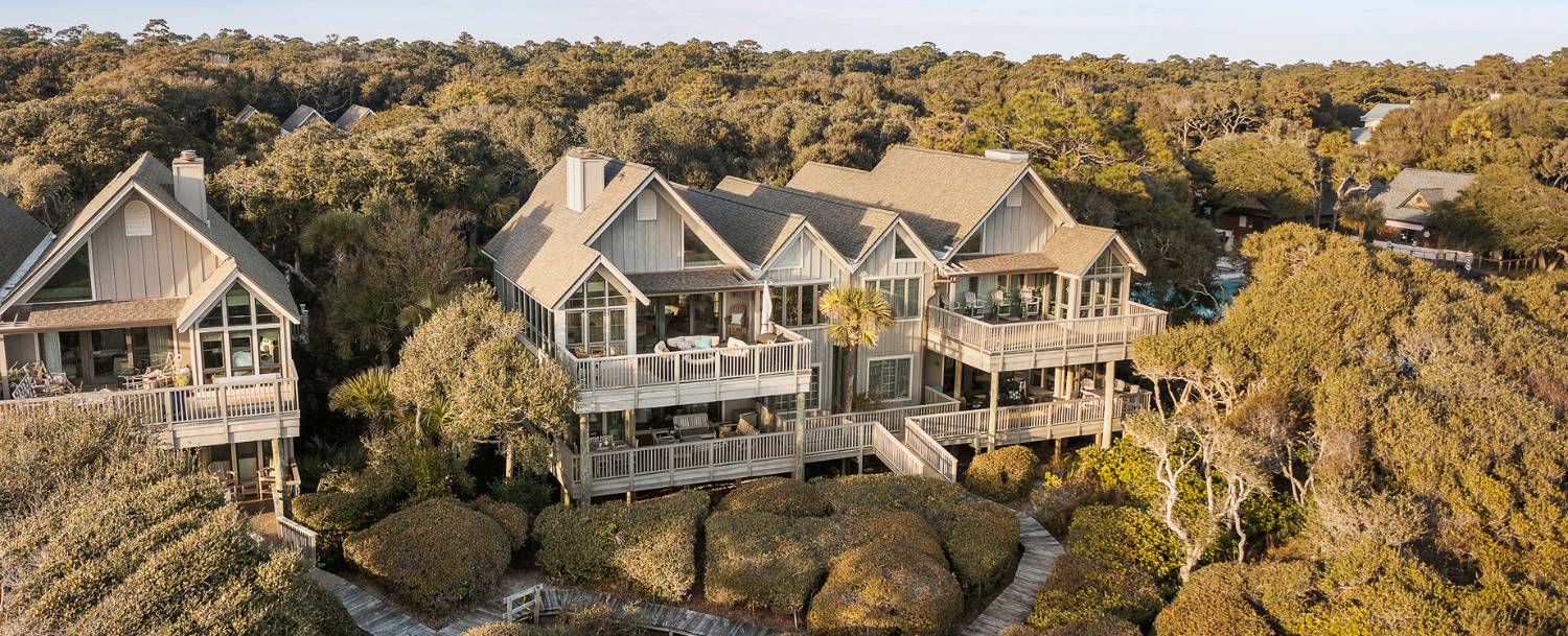 Aerial view of luxury Kiawah Island homes with wraparound decks set among maritime forest, available as Pacaso co-ownership shares