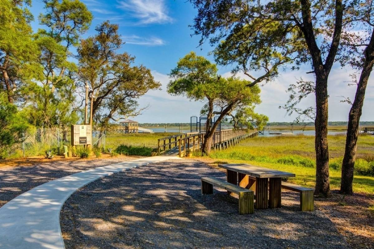 Winding path to community dock with picnic area, marsh grass, and tidal creek views at Kiawah River Estates on Johns Island SC