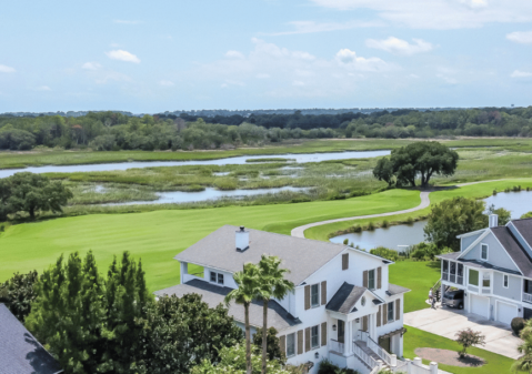 Aerial view of Kiawah River Estates homes alongside golf course fairway, marsh, and tidal ponds on Johns Island SC