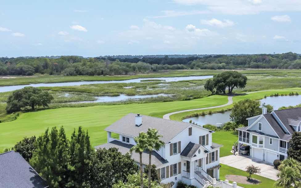Aerial view of Kiawah River Estates homes alongside golf course fairway, marsh, and tidal ponds on Johns Island SC