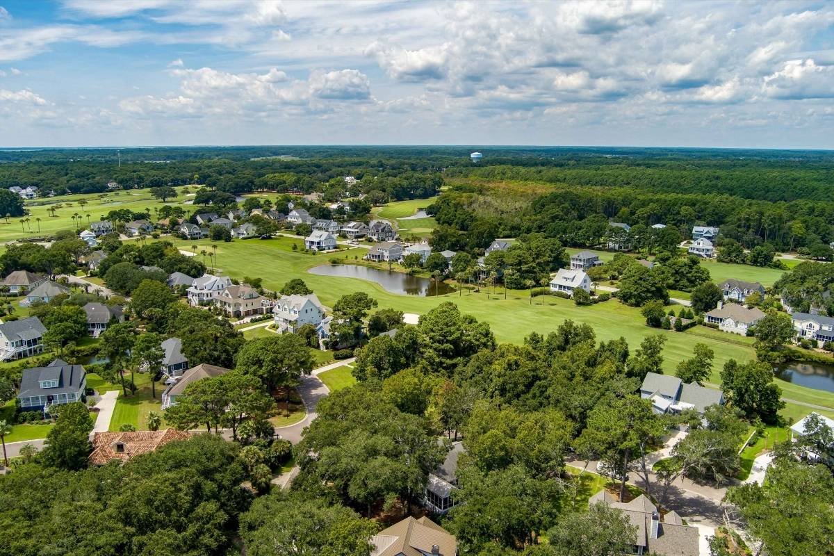 Aerial view of Kiawah River Estates neighborhood homes among mature trees and golf course on Johns Island SC