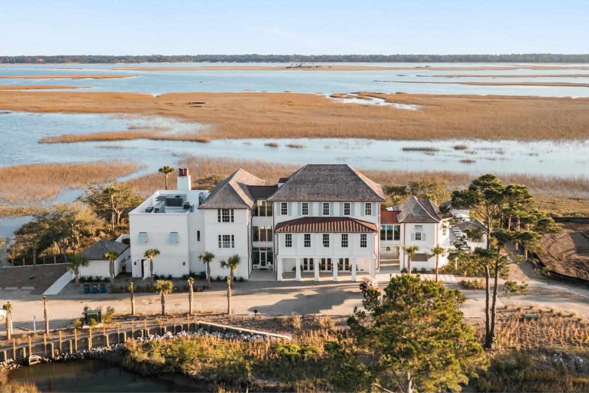 Aerial view of the Spring House amenity center at Kiawah River surrounded by marsh and tidal water, Johns Island SC