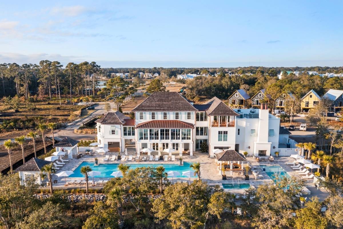 Aerial view of the Spring House amenity center with pools, cabanas, and lounge areas at Kiawah River community, Johns Island SC
