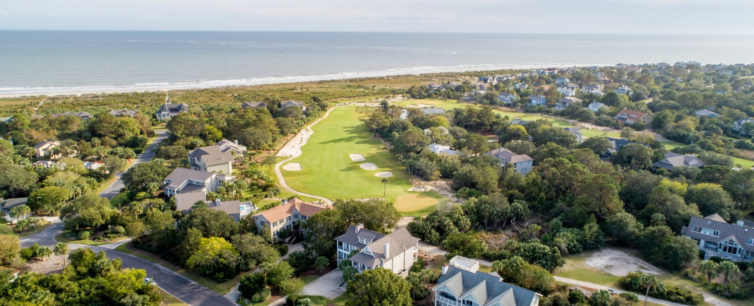 Aerial view of Seabrook Island residential homes and golf course fairways with the Atlantic Ocean and private beach in the background, Seabrook Island, SC