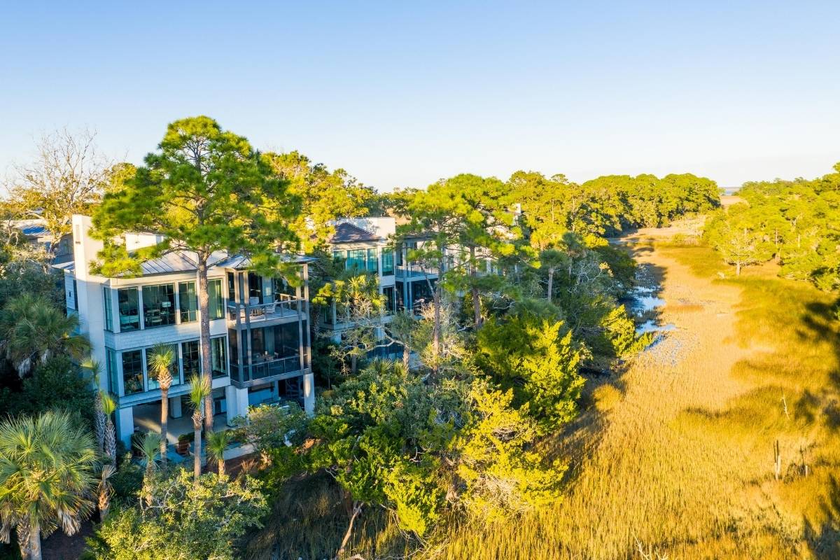Contemporary luxury home with floor-to-ceiling glass and wraparound decks overlooking marsh and tidal creek at The Pointe, Kiawah Island SC